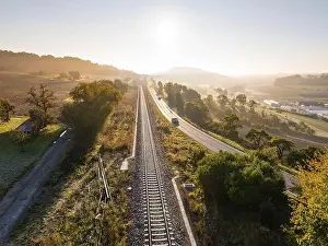 Baden Wuerttemberg Prints: Landscape at sunrise with parallel railway tracks and country road