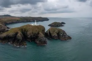 Landscape view of the Pembrokeshire coast with the historic Strumble Head Lighthouse
