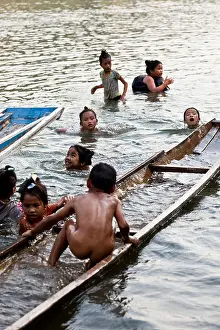 Harmonious Prints: Laotian children playing in the Ou river (Laos)