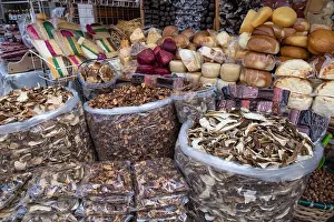 Large bags of dried mushrooms and homemade cheeses displayed on traditional Ukrainian farm market