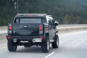 Expressway Prints: A large black Hummer H2 SUV driving on the highway
