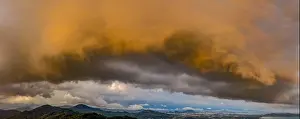 A large cloud and thunderstorm covers Phuket island in sunset time