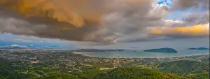 A large cloud and thunderstorm covers Phuket island in sunset time