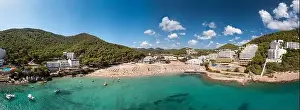 Large format wide angle panoramic aerial photo of the Spanish island of Ibiza showing the beautiful beach front