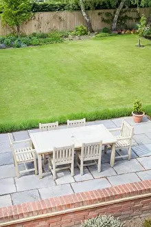 Ideal Prints: Large back garden in UK in summer, with wooden furniture on a garden patio terrace