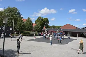 Pupils Prints: A large group of kids playing on the playground during break at school