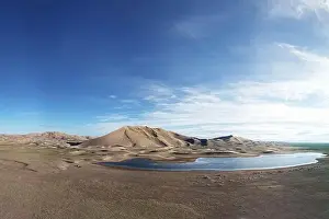 A large lake on the edge of a sandy desert. Mongolia sandy dune desert Mongol Els. Khovd province, Western Mongolia
