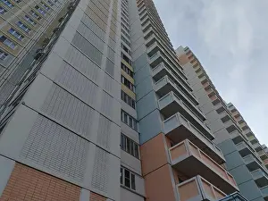 Functional Prints: A large multi-story residential building with a pastel color palette of pink