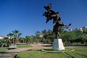 Tunisia Prints: A large sculpture fashioned out of olive wood mounted on a plinth and displayed in a public park in the city of Sfax