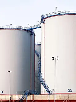 Industrial Site Prints: Large white cylindrical industrial storage tanks with numbered markings and safety railings