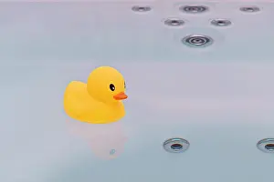 Jacuzzi Prints: Large yellow rubber duck floating in bathtub jacuzzi. Bath time concept