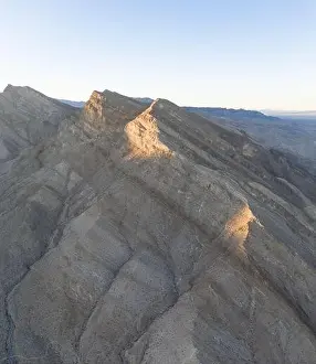 Austere Prints: Late afternoon sunlight creates contrast on the gullies and ravines of the rocky
