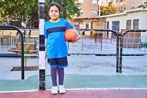 Practicing Prints: of a latin girl goalkeeper football player on a soccer goal with football ball