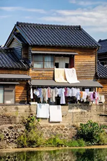 Bedding Prints: Laundry day in Japan: hanging the washing out from the windows of a traditional wooden Japanese house