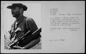 Reconnaissance Prints: LCpl S.M. Leighty takes a break in the sun during a lull in fighting near the DMZ during Operation Prairie II on March