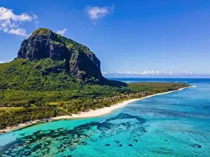 Sand Beach Prints: Le Morne beach Mauritius, Tropical beach with palm trees and white sand blue ocean and beach beds with umbrella