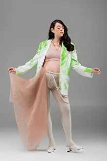 Femininity Prints: full length of brunette mother-to-be in green and white jacket