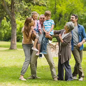 Siblings Prints: Full length of an extended family playing in the park