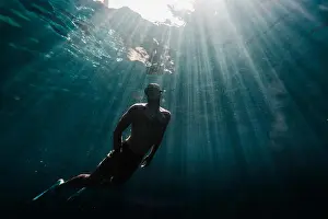 Generation X Prints: Full length of a man swimming underwater in the ocean