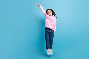Preteen Prints: Full length photo of young girl happy positive smile jump up show hands big huge size isolated over blue color