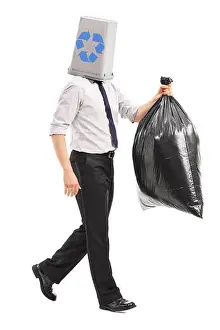 Litter Prints: Full length portrait of a man with a recycle bin over his head carrying a garbage bag