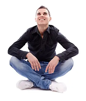 Knees Prints: Full length pose of young man sitting on the floor cross legged