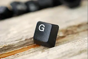 Touch Prints: letter g computer keyboard buttons on old wood background, image