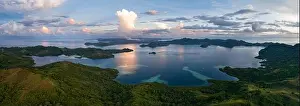 The last light of day illuminates clouds drifting above remote islands in the Solomon Islands. This country is home to high marine biodiversity