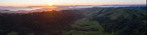 The last light of day illuminates San Francisco Bay and its surrounding cities and hills. This area is bordered by open space in the East Bay