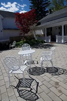 City Street Prints: Light and shadow of the white coloured chairs and table