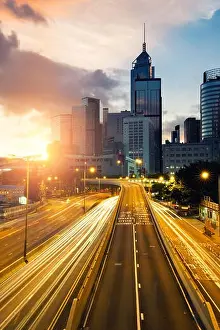 Hong Prints: Light trails of traffic in Hong Kong at sunset time with Hong Kong bussines center in background