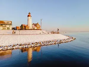 Water Tourism Prints: Lighthouse of Urk during winter with snow landscape in the Netherlands at sunset