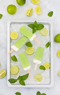 Chilled Prints: Lime mint popsicles, slices of limes and mint leaves on crushed ice