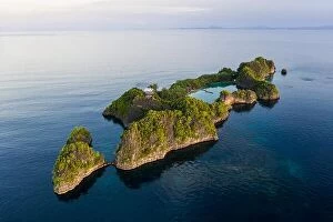 Aerial Landscape Collection: A limestone island surrounds a marine lake in Raja Ampat, Indonesia