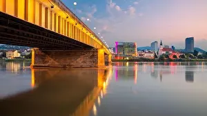 Linz, Austria. Cityscape image of riverside Linz, Austria at summer sunrise with reflection of the city lights in Danube river