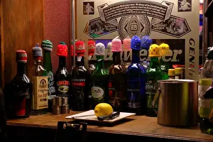 In A Row Prints: Liqueur and sherry bottles with Christmas woollen hats on their tops