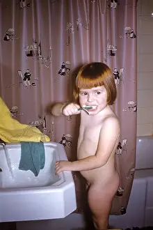 Relaxed Prints: A little girl in her birthday suit, brushing her teeth 1956