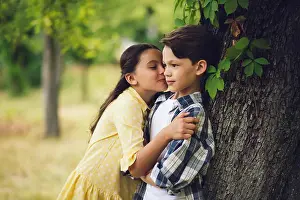 Little girl kissing boy