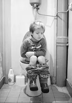Sits Prints: Little girl sitting on toilet, b&w