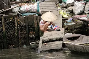 Little Girl using the River Dock as a Toilet, Mekong Delta, Vietnam
