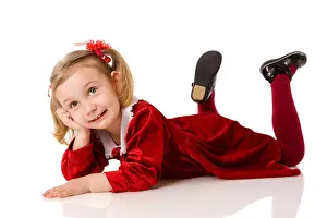 Lying Down Prints: Little girl wearing beautiful dress lying down isolated on white