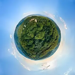 Little planet globe with dark mountain hills covered with green mixed pine