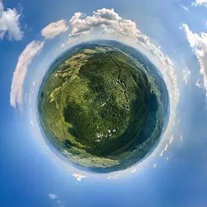 Little planet globe with dark mountain hills covered with green mixed pine