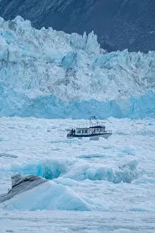 Nature Conservation Prints: Little ship floating between the ice below the Eqi glacier