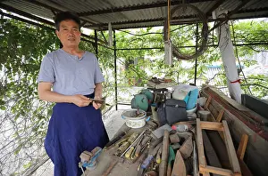 Replication Prints: Local Chinese resident Mao Naimin works on his homemade replicas of the ancient weaponry of Qin Dynasty (221-206 BC)