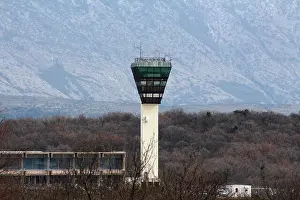 Snow Mountain Prints: Local small airport control tower with partially snow covered mountain and dried woods in background on cold winter day
