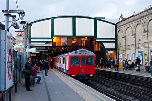 Platform Prints: London District line tube underground train is leaving West Brompton station