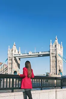 Tower Bridge Prints: London people lifestyle city tourist woman looking at view of Tower Bridge in red trench coat