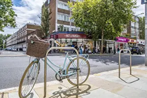 Shop Sign Prints: London, UK- August 6, 2023: Retro Womens Bicycle with basket parked in Chelsea in front of Pret a Manger coffee shop