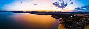 Murray River Prints: Lonely boat sailing across scenic lake at vivid orange sunset - aerial panorama